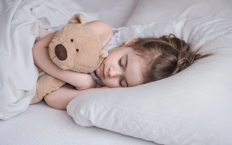 cute-little-girl-sleeps-sweetly-in-a-white-cozy-bed-with-a-soft-bear-toy-the-concept-of-children-s-rest-and-sleep_169016-4738.jpg